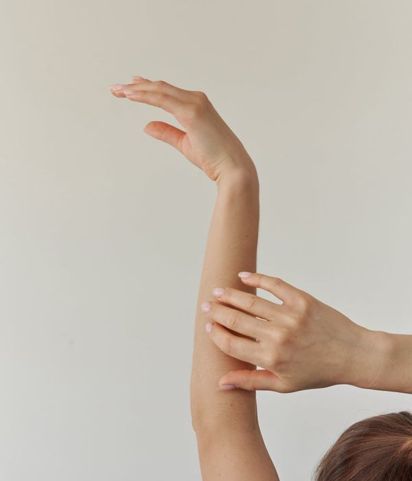 Woman in a graceful yoga pose with mint light accents.